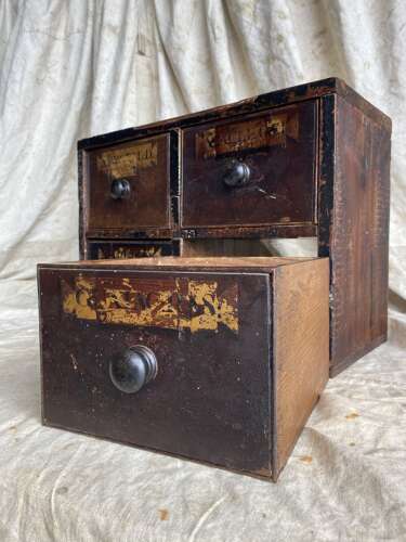 A bank of antique early 19th century mahogany and pine apothecary drawers