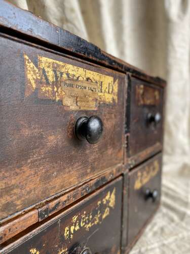 A bank of antique early 19th century mahogany and pine apothecary drawers