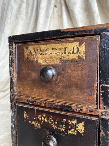 A bank of antique early 19th century mahogany and pine apothecary drawers