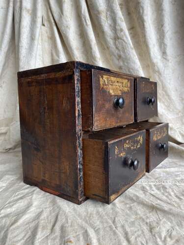 A bank of antique early 19th century mahogany and pine apothecary drawers