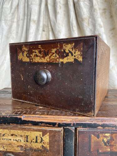 A bank of antique early 19th century mahogany and pine apothecary drawers