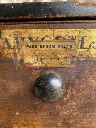 A bank of antique early 19th century mahogany and pine apothecary drawers