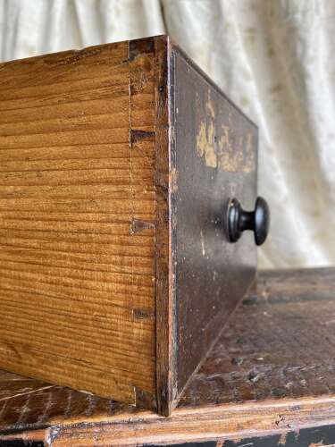 A bank of antique early 19th century mahogany and pine apothecary drawers