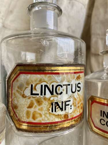 A large collection of antique Victorian glass apothecary chemist bottles