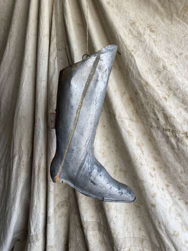 An antique early 20th century English bootmakers metal trade sign