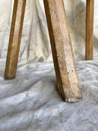 An antique Georgian elm dairy stool with iron strap repair