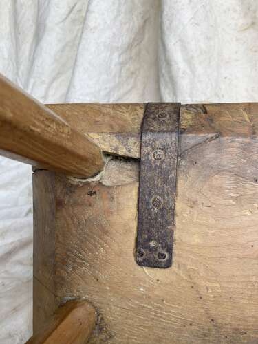 An antique Georgian elm dairy stool with iron strap repair