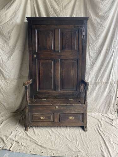 A charming antique English 18th century oak bacon back settle of small proportions