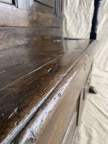 A charming antique English 18th century oak bacon back settle of small proportions