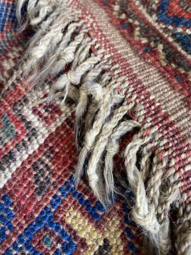A large antique Persian late 19th century hand knotted Qashqai Khamseh rug