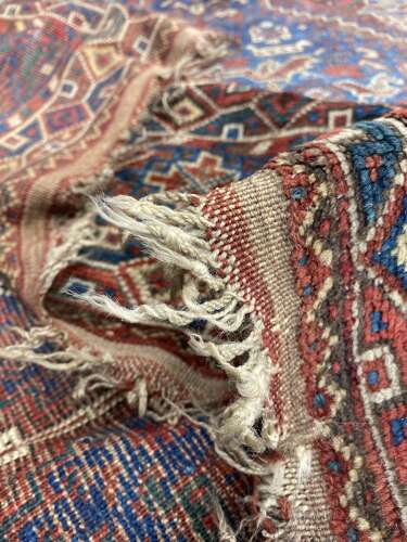 A large antique Persian late 19th century hand knotted Qashqai Khamseh rug