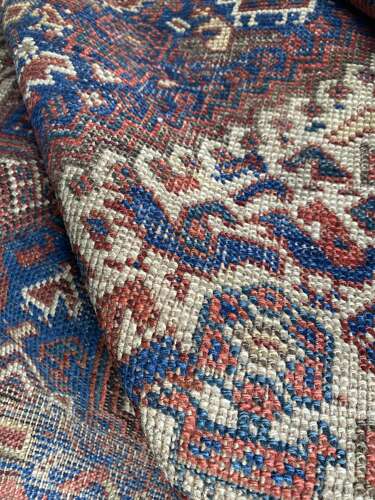 A large antique Persian late 19th century hand knotted Qashqai Khamseh rug