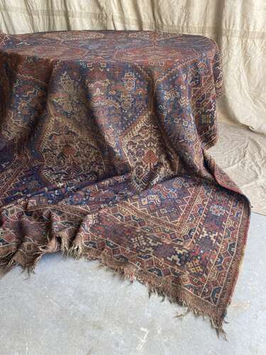 A large antique Persian late 19th century hand knotted Qashqai Khamseh rug