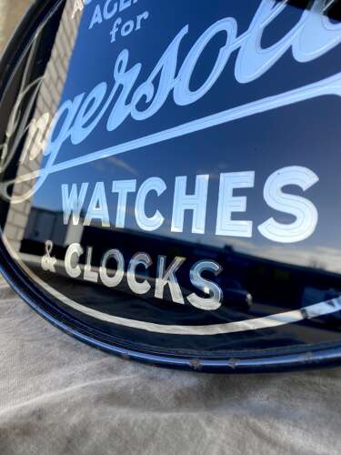 An early 20th century antique double sided glass advertising sign for Ingersoll watches