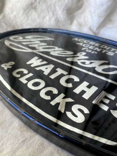 An early 20th century antique double sided glass advertising sign for Ingersoll watches