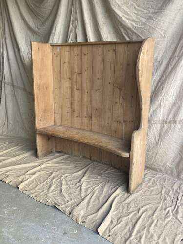 An antique 19th century pine barrel back settle