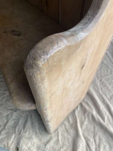 An antique 19th century pine barrel back settle
