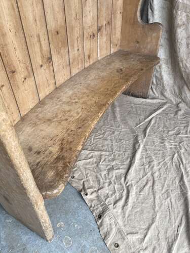 An antique 19th century pine barrel back settle