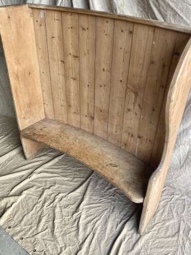An antique 19th century pine barrel back settle
