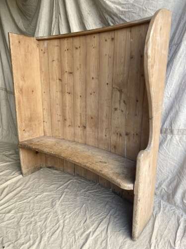 An antique 19th century pine barrel back settle