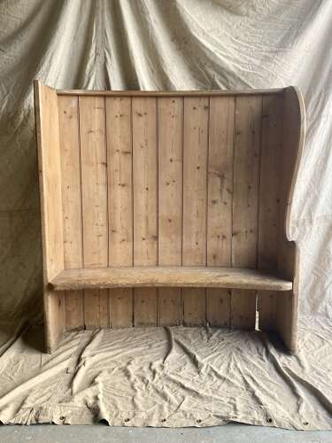 An antique 19th century pine barrel back settle