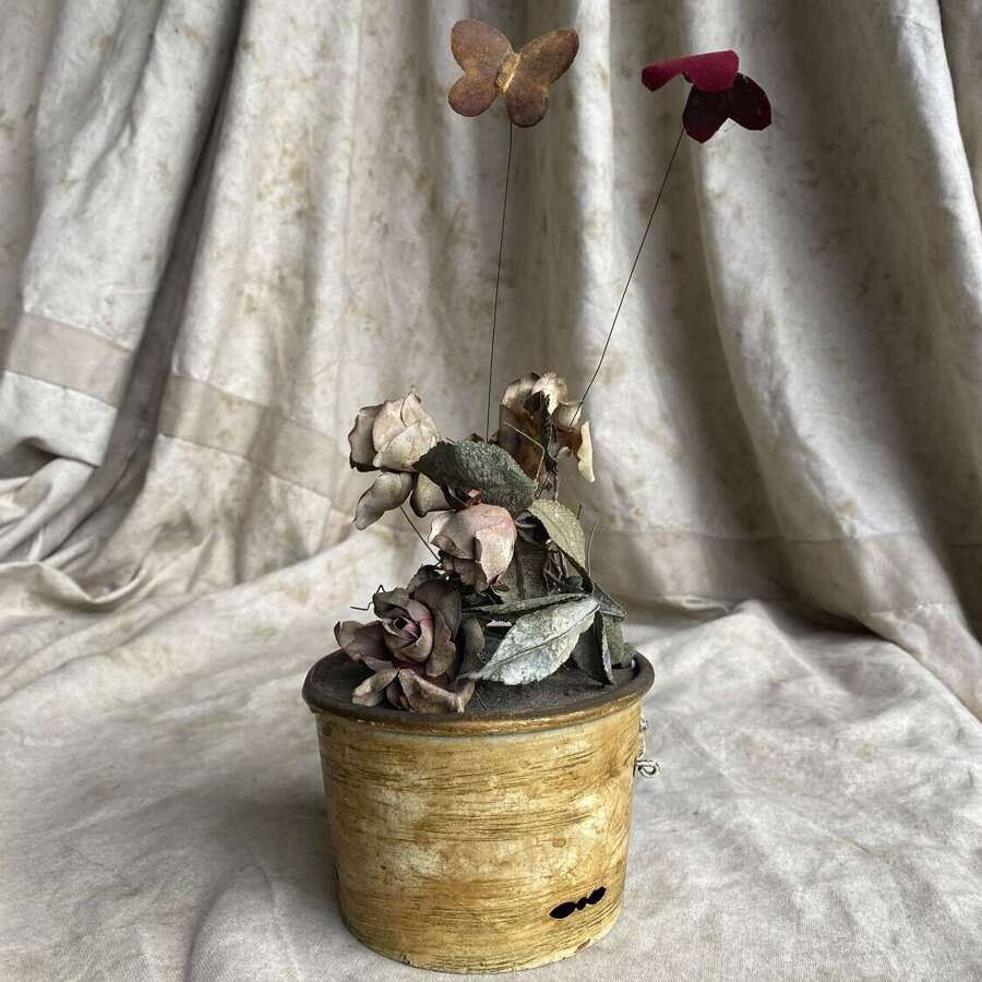 An antique clockwork musical toleware fabric flower and butterfly automaton