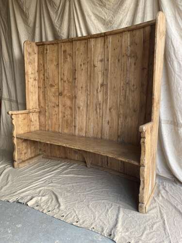 A 19th century antique English pine and oak high barrel back tavern settle