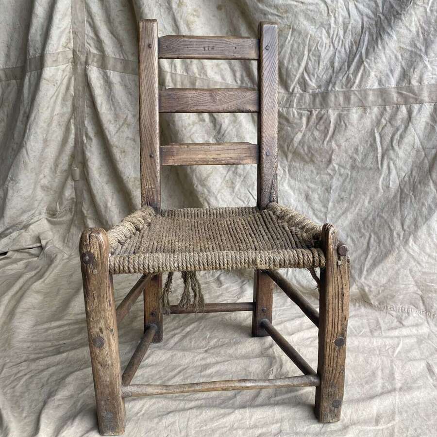 An antique mid 19th century vernacular Irish elm Sugan chair