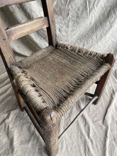 An antique mid 19th century vernacular Irish elm Sugan chair