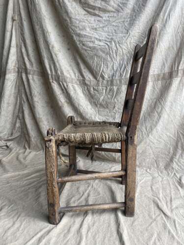 An antique mid 19th century vernacular Irish elm Sugan chair