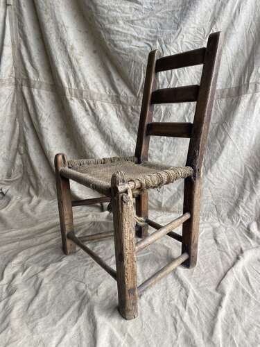 An antique mid 19th century vernacular Irish elm Sugan chair