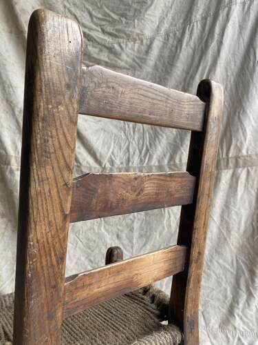An antique mid 19th century vernacular Irish elm Sugan chair