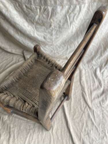 An antique mid 19th century vernacular Irish elm Sugan chair
