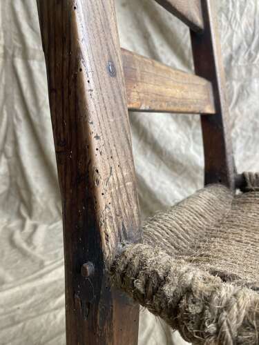 An antique mid 19th century vernacular Irish elm Sugan chair