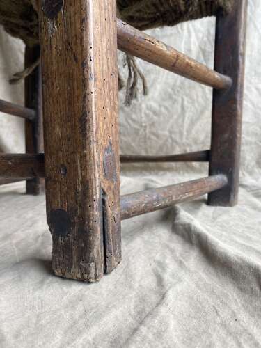An antique mid 19th century vernacular Irish elm Sugan chair