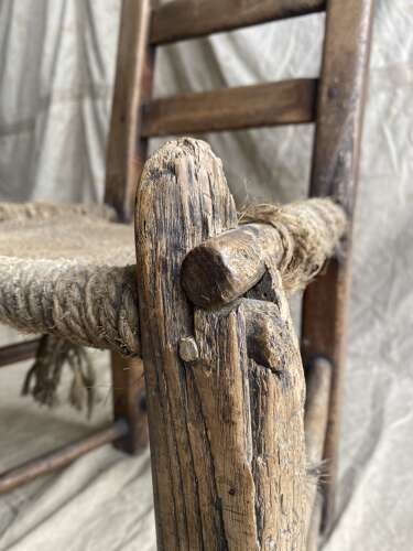 An antique mid 19th century vernacular Irish elm Sugan chair