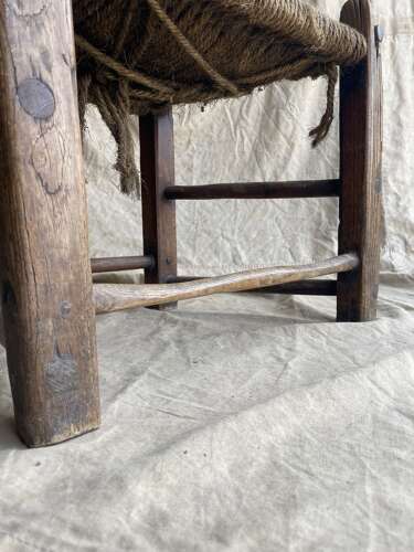 An antique mid 19th century vernacular Irish elm Sugan chair