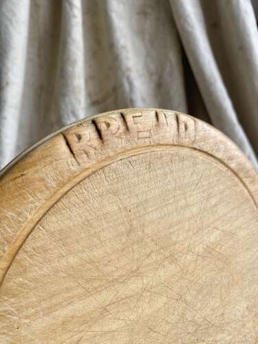 An antique English carved early 20th century sycamore breadboard