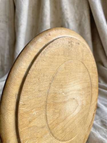 An antique English carved early 20th century sycamore breadboard