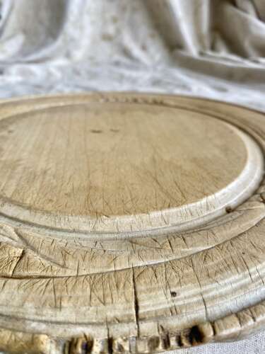 An antique late 19th century English carved sycamore breadboard