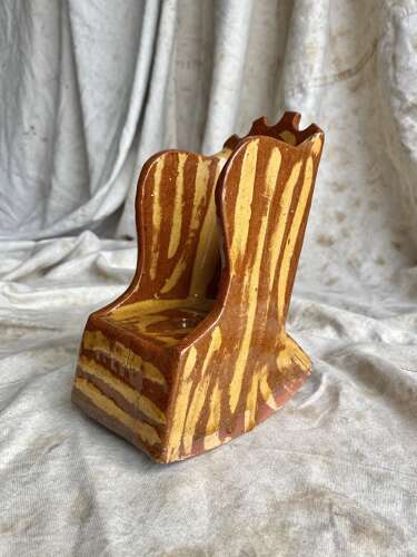 A 19th century antique Yorkshire folk art slipware pottery model of a lambing chair