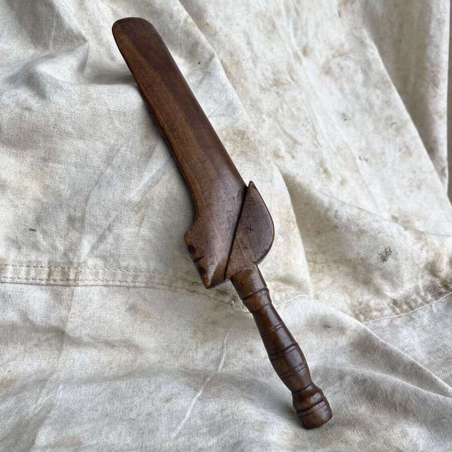An antique early 19th century folk art fruitwood knitting sheath with apotropaic symbol
