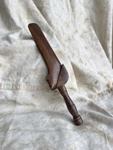 An antique early 19th century folk art fruitwood knitting sheath with apotropaic symbol