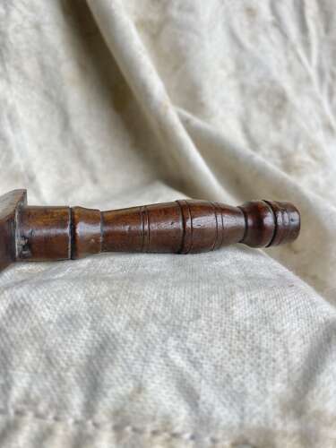 An antique early 19th century folk art fruitwood knitting sheath with apotropaic symbol