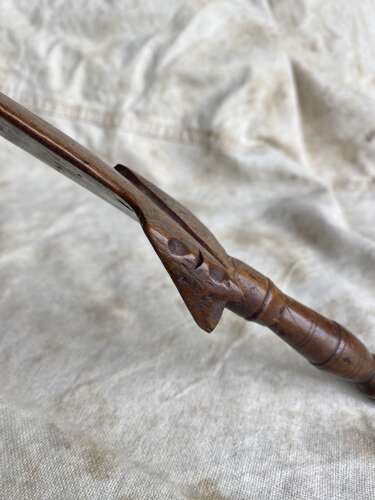 An antique early 19th century folk art fruitwood knitting sheath with apotropaic symbol