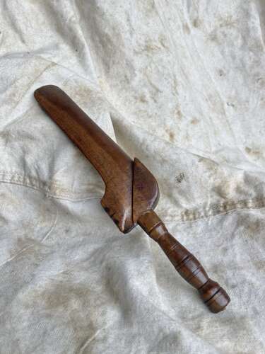 An antique early 19th century folk art fruitwood knitting sheath with apotropaic symbol