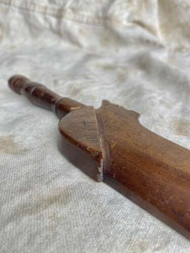 An antique early 19th century folk art fruitwood knitting sheath with apotropaic symbol