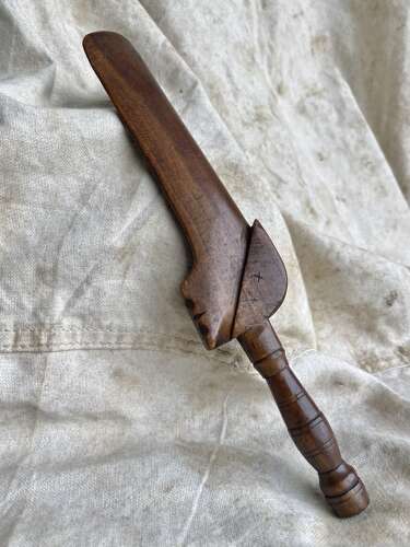 An antique early 19th century folk art fruitwood knitting sheath with apotropaic symbol