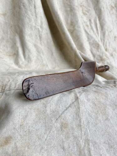 An antique early 19th century folk art fruitwood knitting sheath with apotropaic symbol