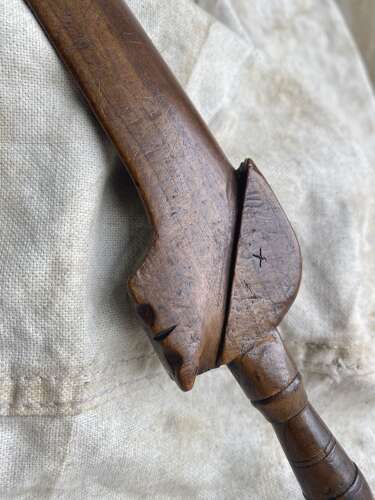 An antique early 19th century folk art fruitwood knitting sheath with apotropaic symbol